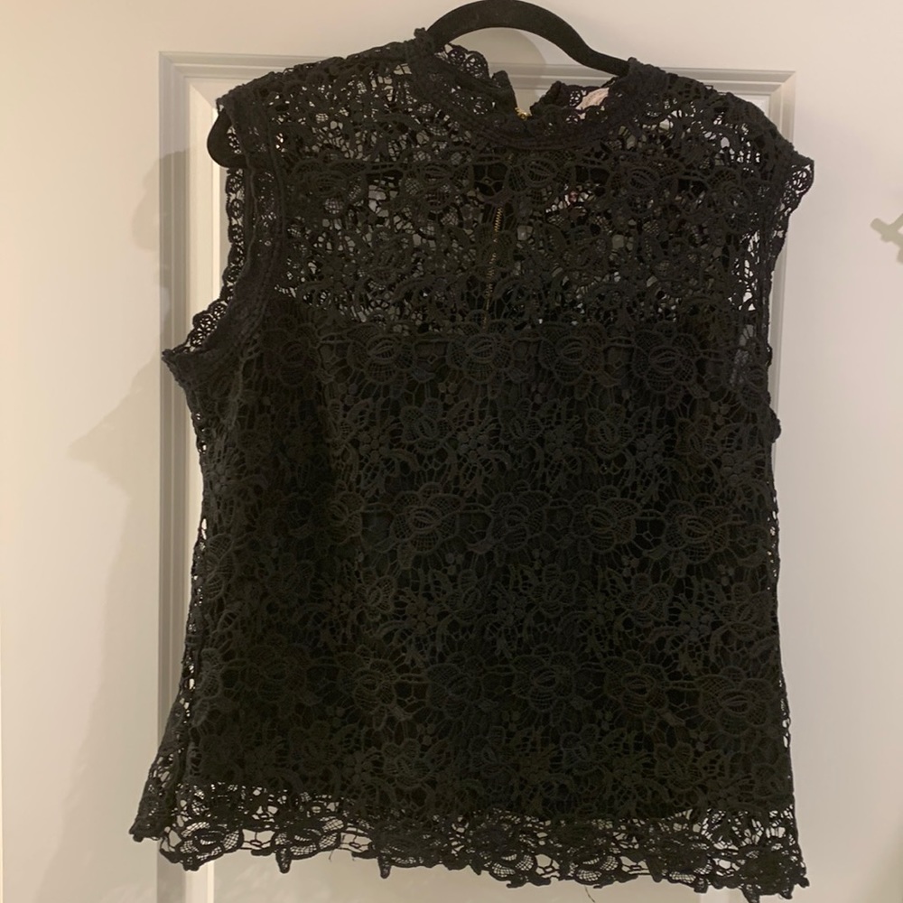 Exquisite black, lace blouse over a black camisole.